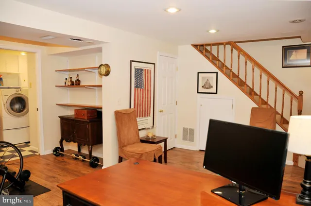 a room with furniture a flat screen tv and a window