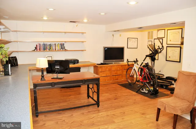 a bathroom with a granite countertop sink a toilet and a window