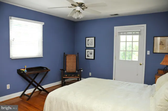 a living room with furniture and a book shelf