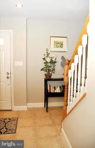 a white house that has a tree in front of it