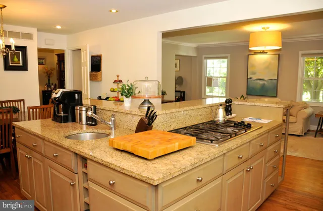 a view of a dining room with furniture and a kitchen