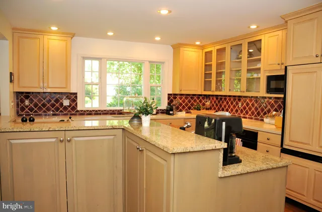 a living room with furniture a fireplace and a large window