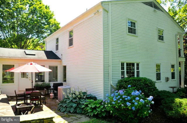 a front view of a house with sitting area