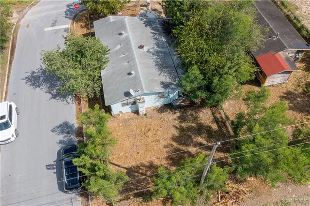 an aerial view of a house with a yard