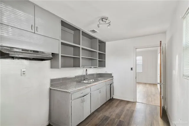 a kitchen with a sink and cabinets