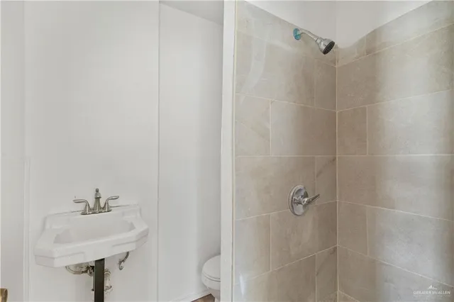a bathroom with a sink a shower and a mirror