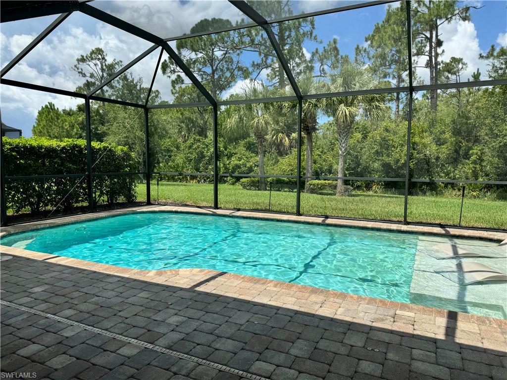 10840 Rutherford Road Fort Myers, FL 33913 - Photo 27 of 35 View of pool featuring glass enclosure and a patio area