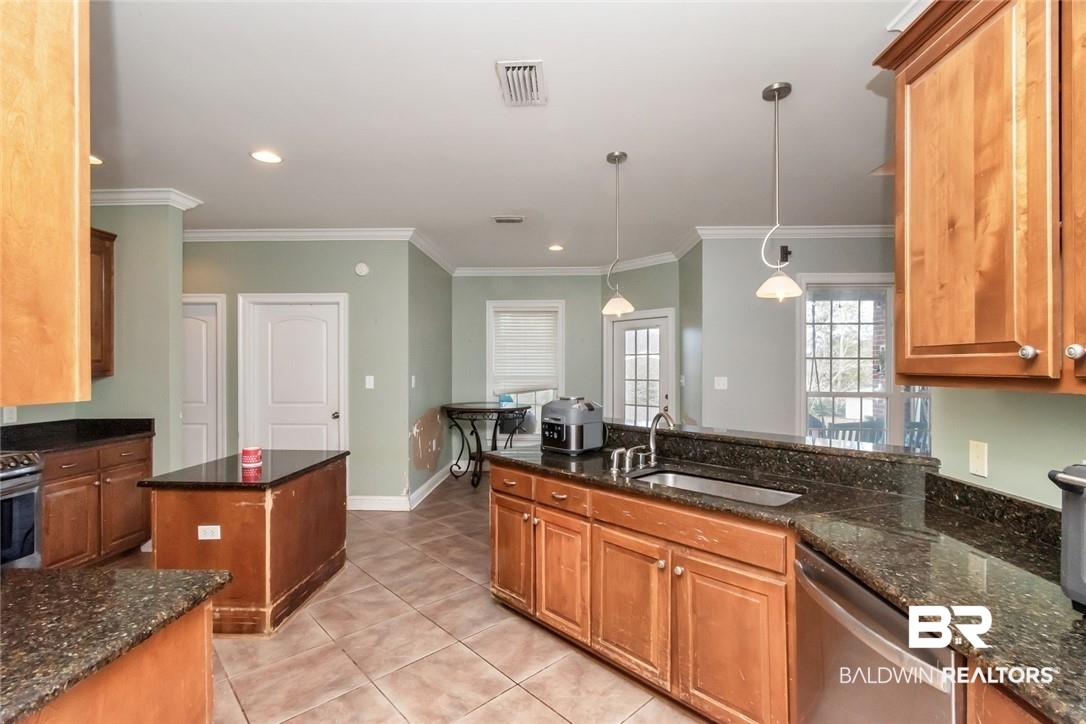 7170 Pierson Drive Mobile, AL 36619 - Photo 5 of 29 Kitchen with hanging light fixtures, a center island, sink, stainless steel dishwasher, and dark stone counters