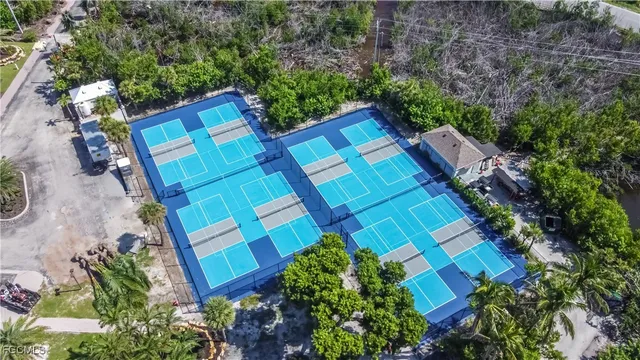 an aerial view of residential houses with outdoor space and ocean view