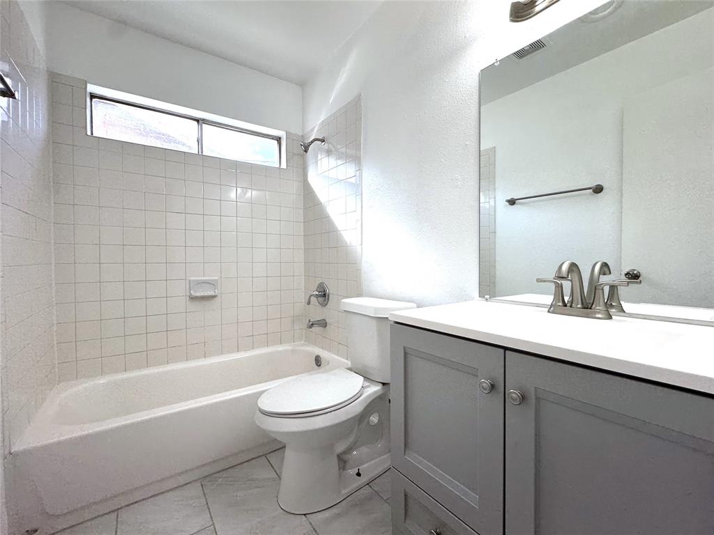 1612 Fairfield Drive Plano, TX 75074 - Photo 11 of 21 Full shared bathroom has Corian countertops and built-in cabinets.