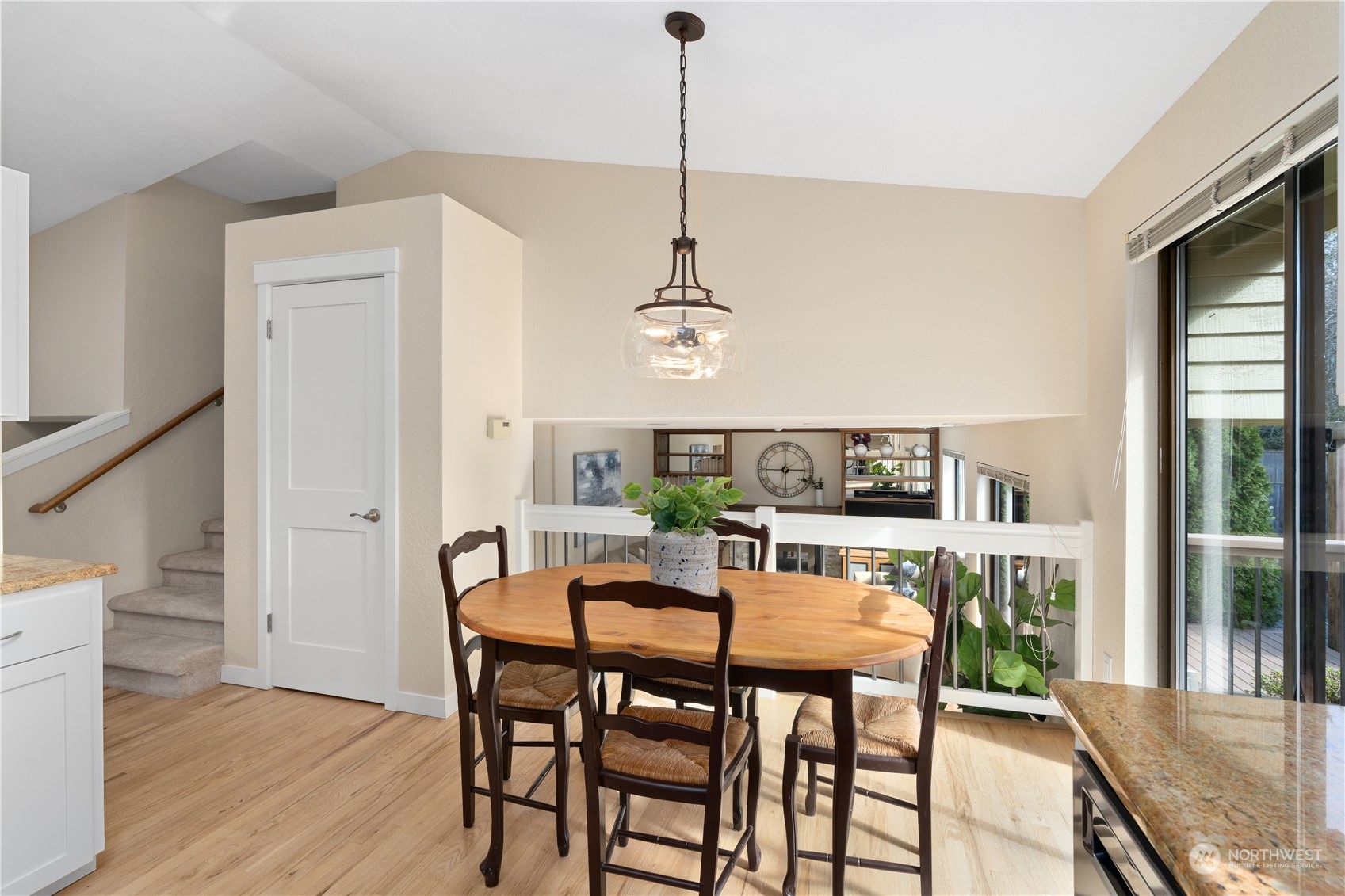 2402 169th Place Southeast Bothell, WA 98012 - Photo 13 of 38 a view of a dining room with furniture window and wooden floor