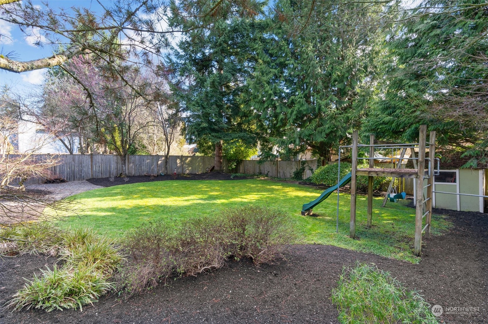 2402 169th Place Southeast Bothell, WA 98012 - Photo 34 of 38 a view of a backyard with swings