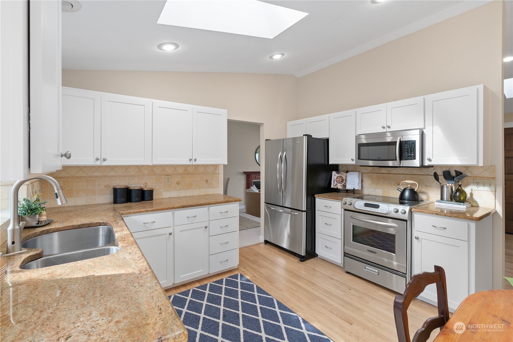 2402 169th Place Southeast Bothell, WA 98012 - Photo 10 of 38 a kitchen with stainless steel appliances granite countertop a refrigerator stove microwave and sink
