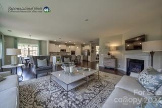 2973 Findley Road, Unit BF6 202 Statesville, NC 28625 - Photo 12 of 34 a living room with furniture a fireplace and a dining table with wooden floor