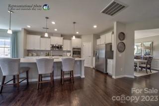 2973 Findley Road, Unit BF6 202 Statesville, NC 28625 - Photo 2 of 34 a kitchen with stainless steel appliances granite countertop a dining table chairs refrigerator and sink