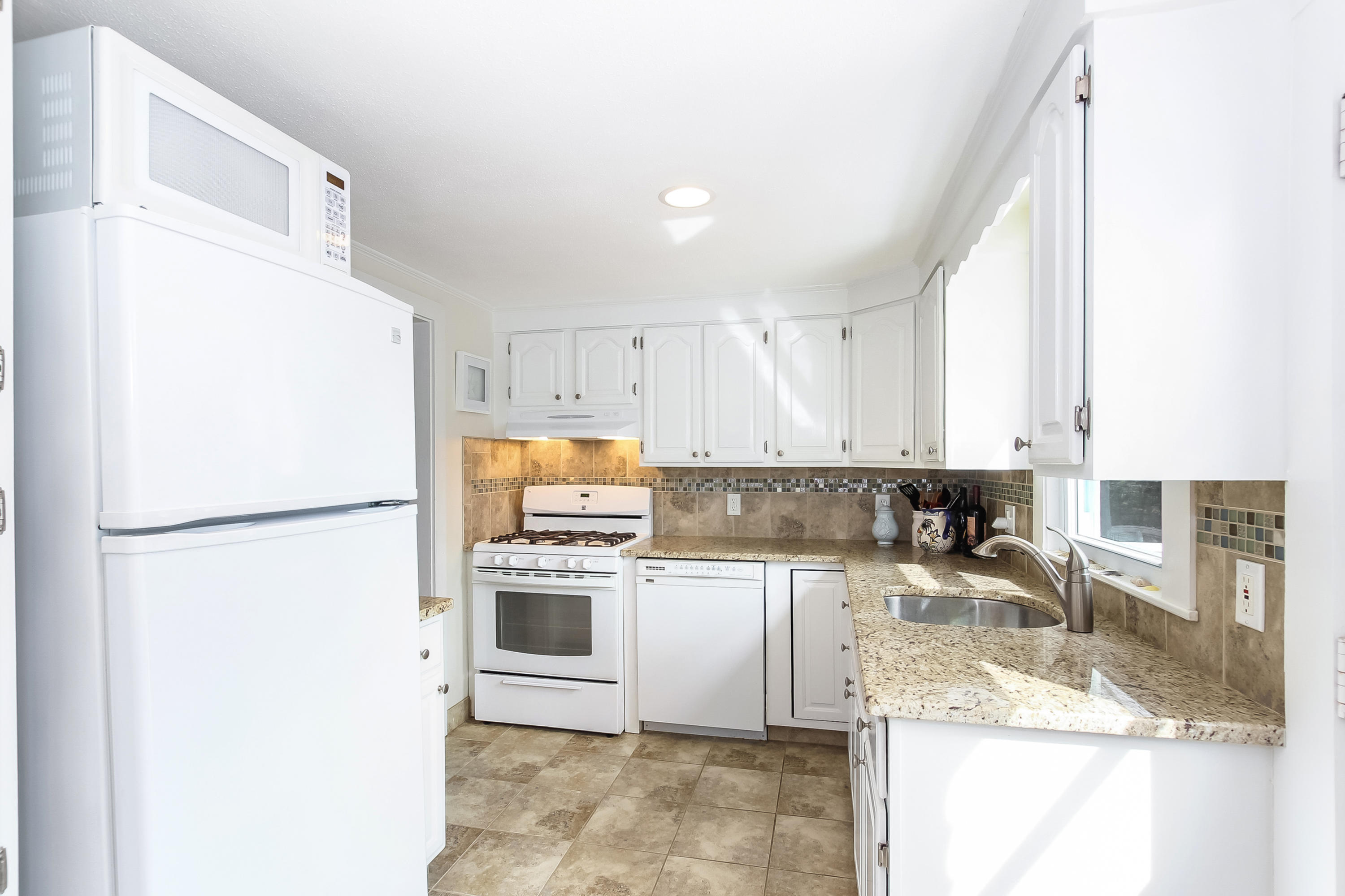 348 Strawberry Hill Road Centerville, MA 02632 - Photo 16 of 32 a kitchen with a refrigerator sink stove and microwave