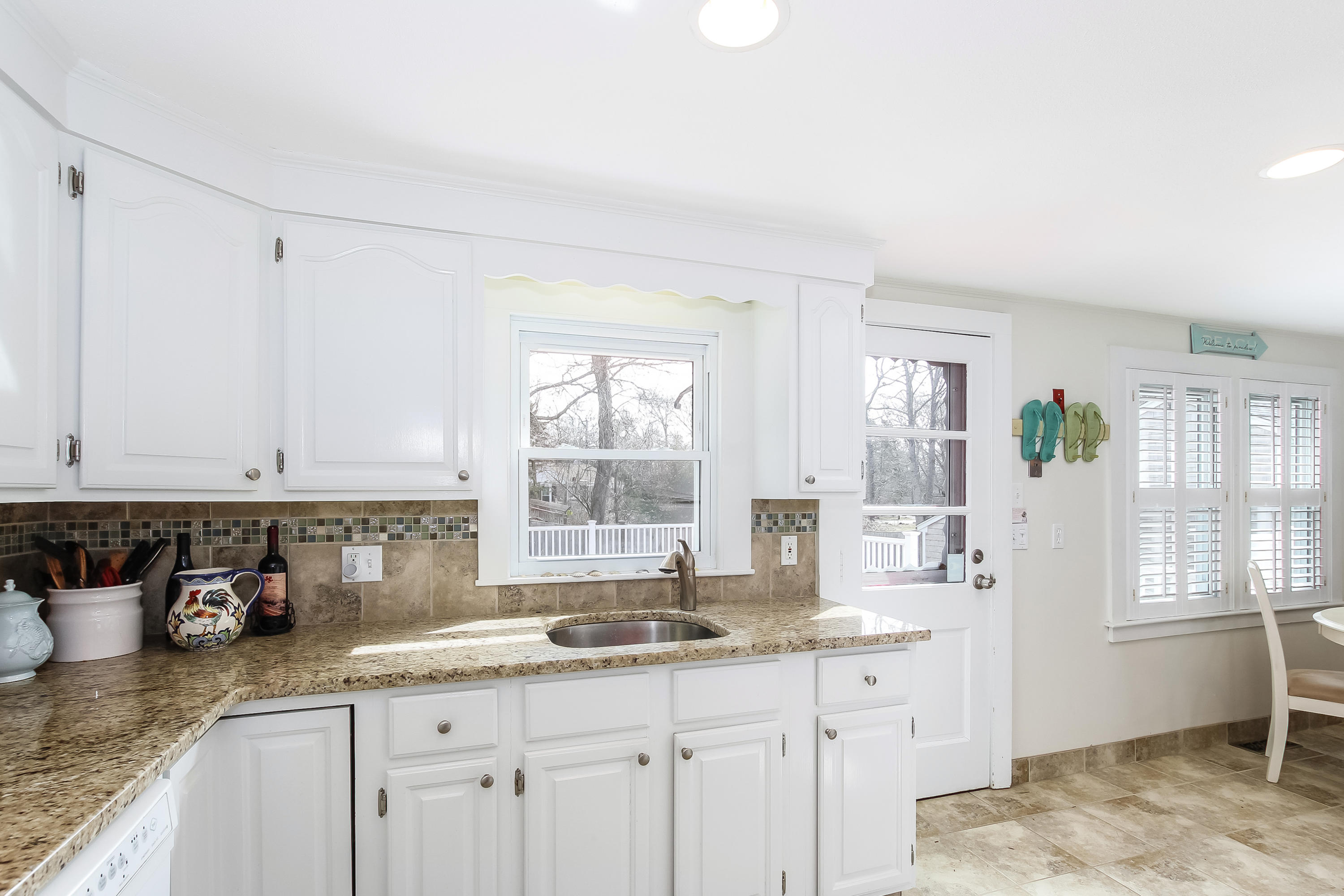 348 Strawberry Hill Road Centerville, MA 02632 - Photo 17 of 32 a kitchen with granite countertop a sink a stove and cabinets