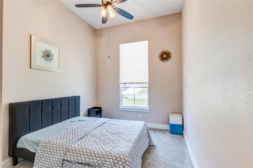 126 LITTLE Strm Cove Austin, TX 78737 - Photo 31 of 40 A comfortable bedroom features high vaulted ceilings and a window providing natural light.