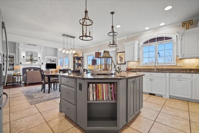 a kitchen with stainless steel appliances kitchen island granite countertop a sink and cabinets