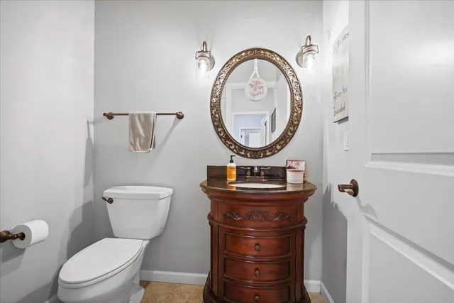 a bathroom with a toilet a sink and a mirror