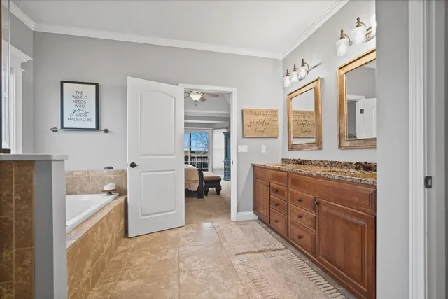 a spacious bathroom with a granite countertop tub sink a mirror and a shower