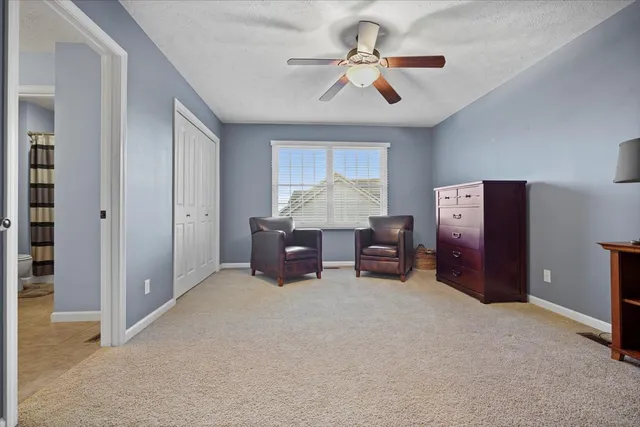 a big room with furniture and a ceiling fan