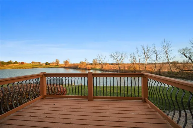 a view of balcony with wooden floor and fence