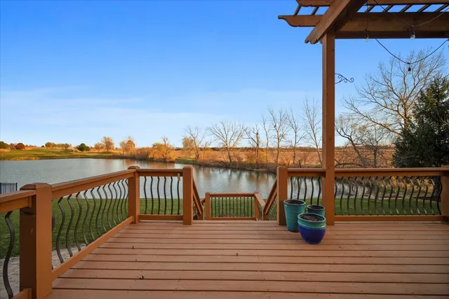 a front view of a house with a garden and trees