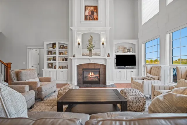 a living room with furniture a flat screen tv and a fireplace