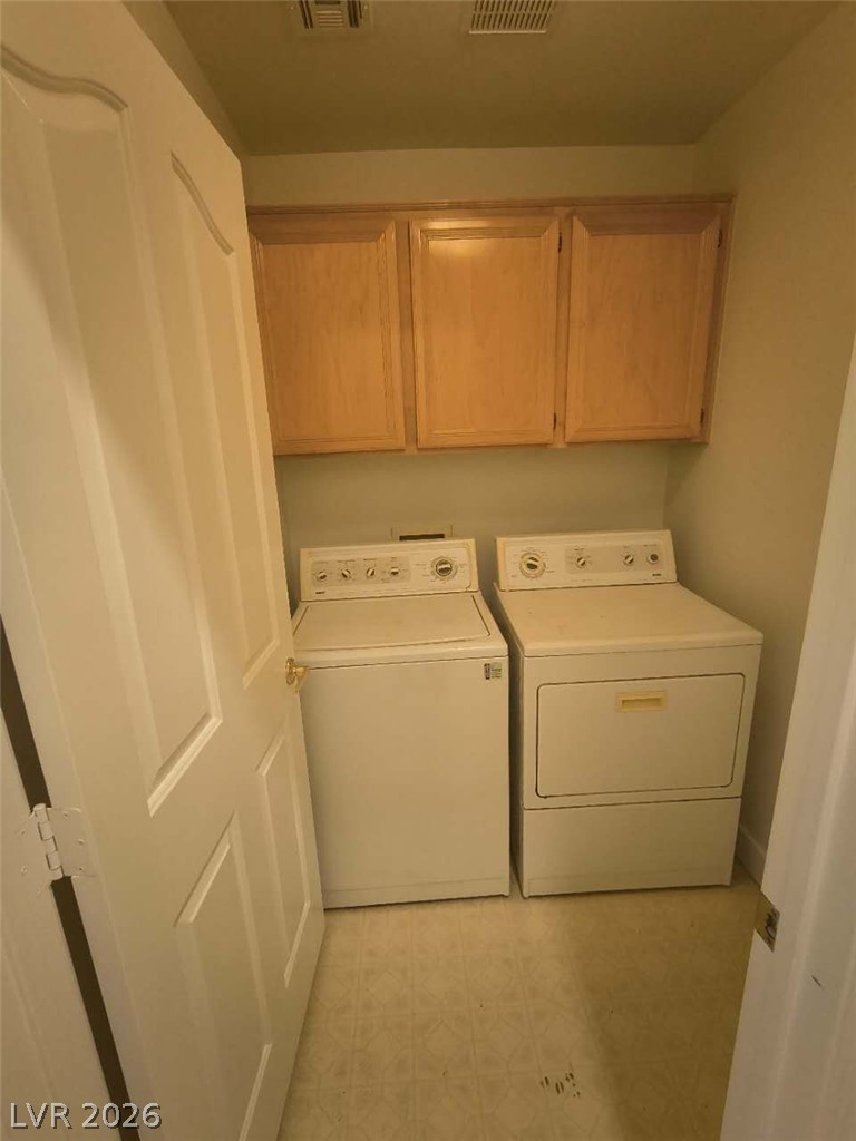 9725 Pima Point Avenue Las Vegas, NV 89147 - Photo 22 of 35 Functional laundry space featuring convenient cabinetry and a dedicated washer and dryer setup.