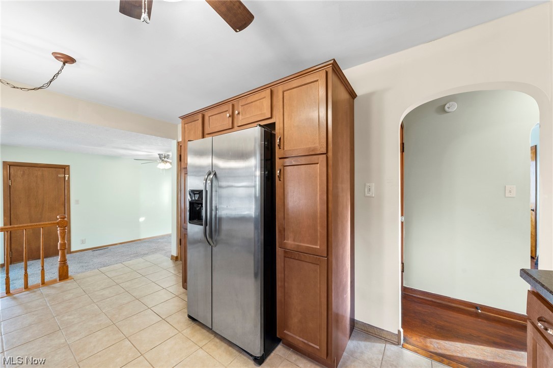 227 South Messner Road New Franklin, OH 44319 - Photo 27 of 44 Kitchen with light hardwood / wood-style floors, ceiling fan, and stainless steel fridge with ice dispenser