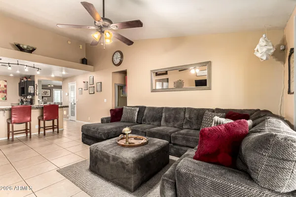a living room with furniture and a chandelier