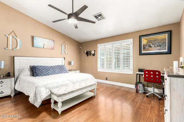 a bedroom with a bed and a table in it