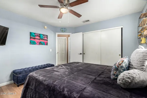 a bedroom with a large bed and a window