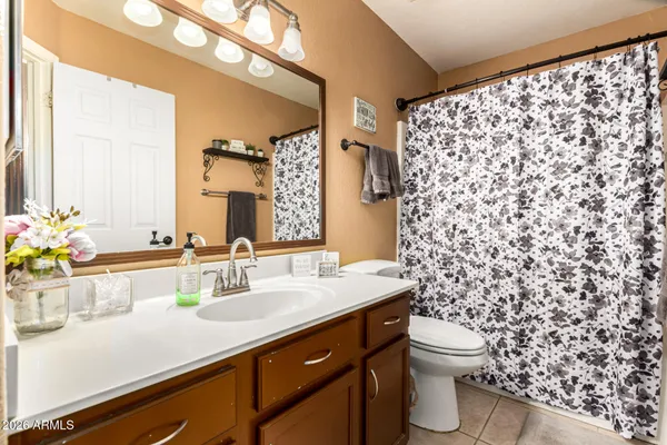 a bathroom with a sink mirror vanity and toilet