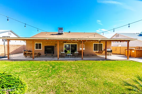a front view of a house with swimming pool having outdoor seating
