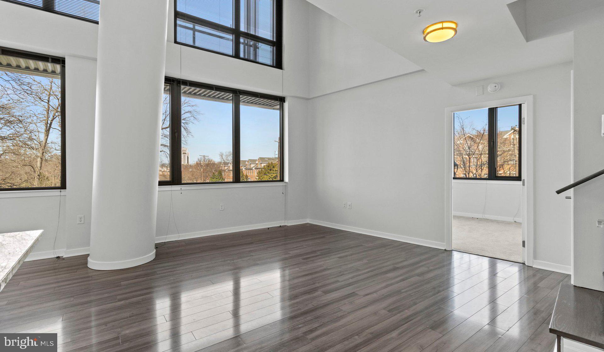 8300 Wisconsin Avenue, Unit 2B1617 Bethesda, MD 20814 - Photo 145 of 150 a view of an empty room with a window and wooden floor