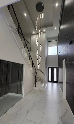 a large white kitchen with a large window