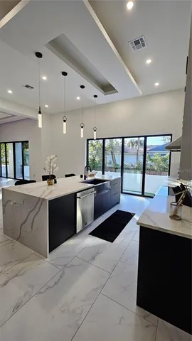 a view of a kitchen with a table and chairs in it