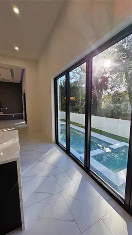 a view of a kitchen with kitchen island dining table and stainless steel appliances