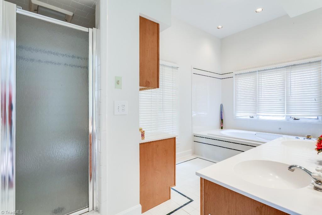 4426 Johnson Street High Point, NC 27265 - Photo 21 of 30 Large master bath with separate shower, his and hers walk in closets, jetted tub, and double sink vanity.