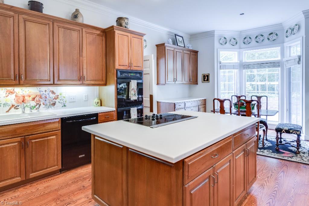 4426 Johnson Street High Point, NC 27265 - Photo 9 of 30 Solid surface counter tops, beautiful cherry cabinets, double built-in ovens, island cooktop, and breakfast bay window space providing an abundance of light.