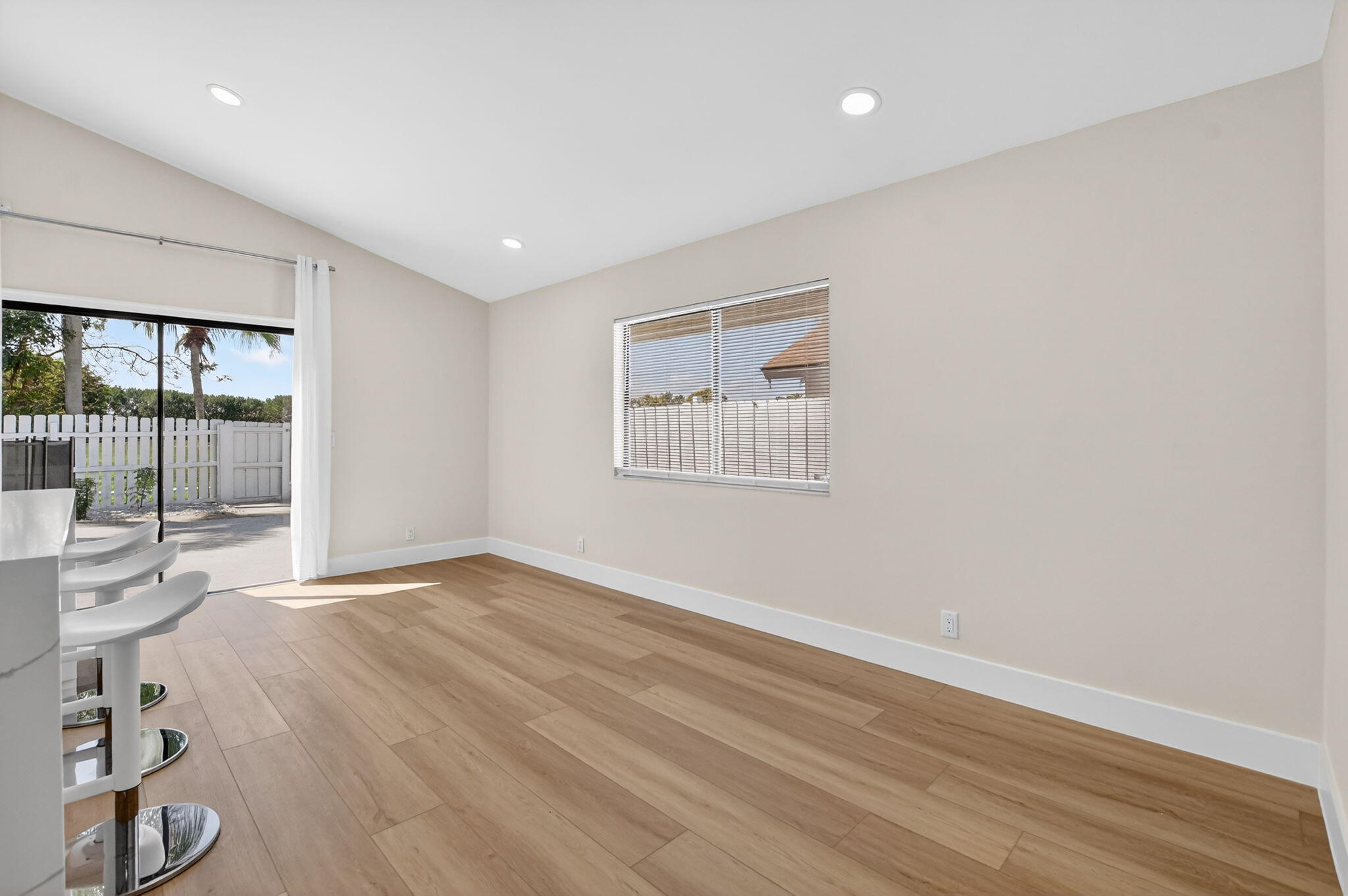 22732 Pickerel Circle Boca Raton, FL 33428 - Photo 11 of 38 a view of an empty room with wooden floor and a window