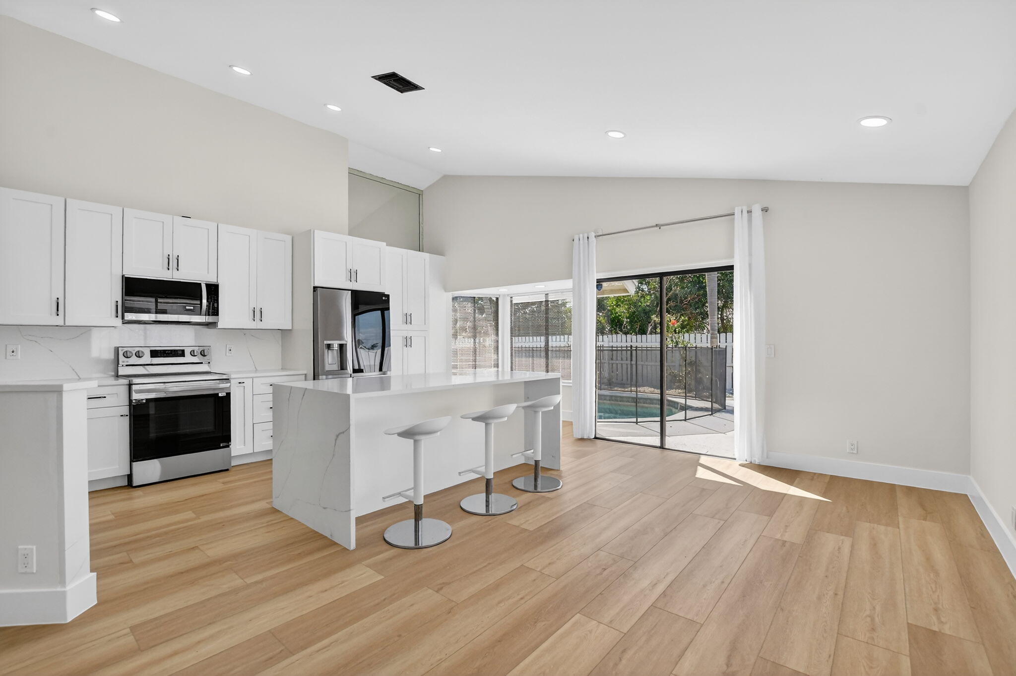 22732 Pickerel Circle Boca Raton, FL 33428 - Photo 12 of 38 a view of kitchen with microwave stove refrigerator and cabinets