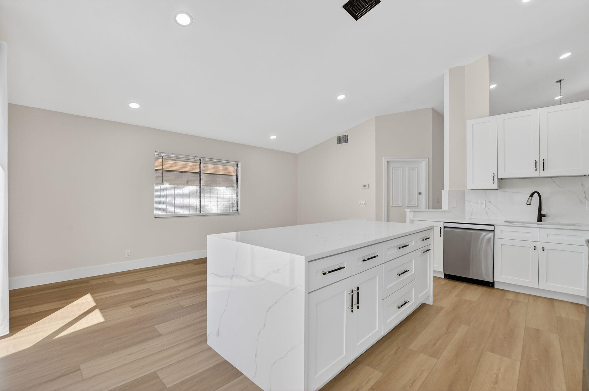 22732 Pickerel Circle Boca Raton, FL 33428 - Photo 15 of 38 a kitchen that has a lot of white cabinets and wooden floor