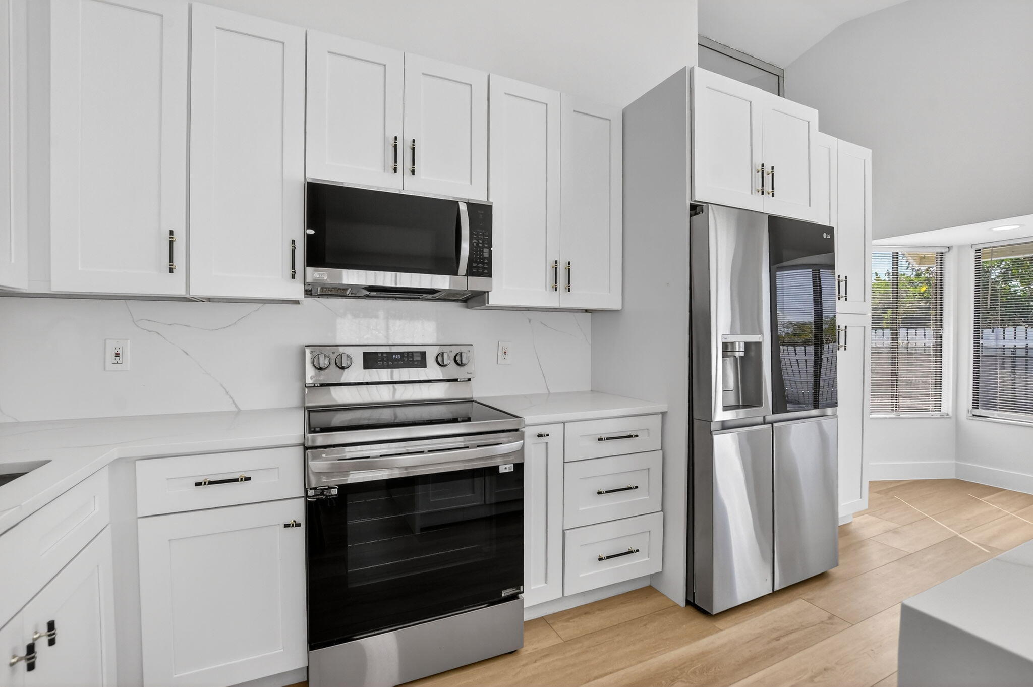 22732 Pickerel Circle Boca Raton, FL 33428 - Photo 17 of 38 a kitchen with stainless steel appliances white cabinets and a stove