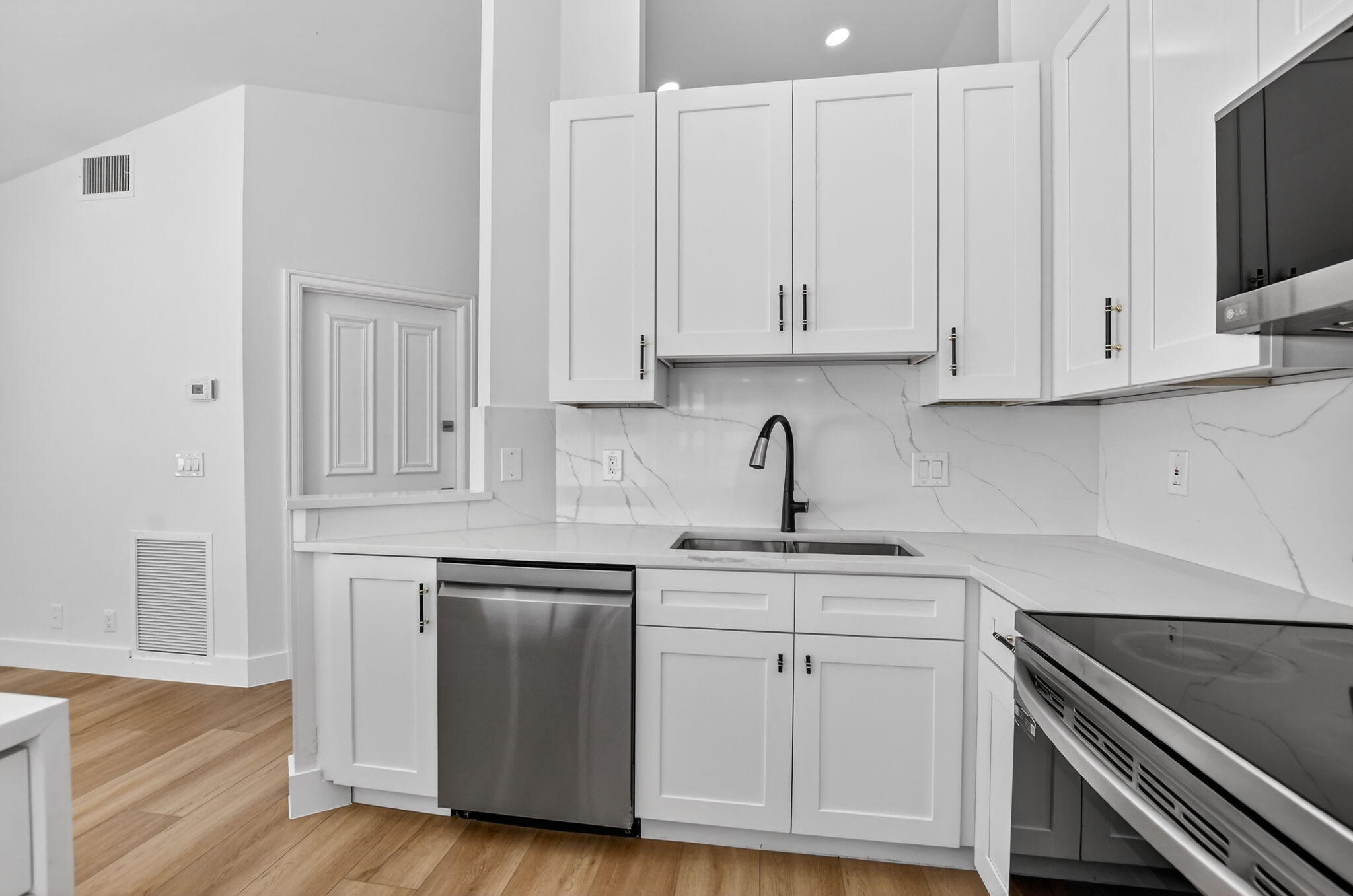 22732 Pickerel Circle Boca Raton, FL 33428 - Photo 18 of 38 a kitchen with white cabinets and a sink