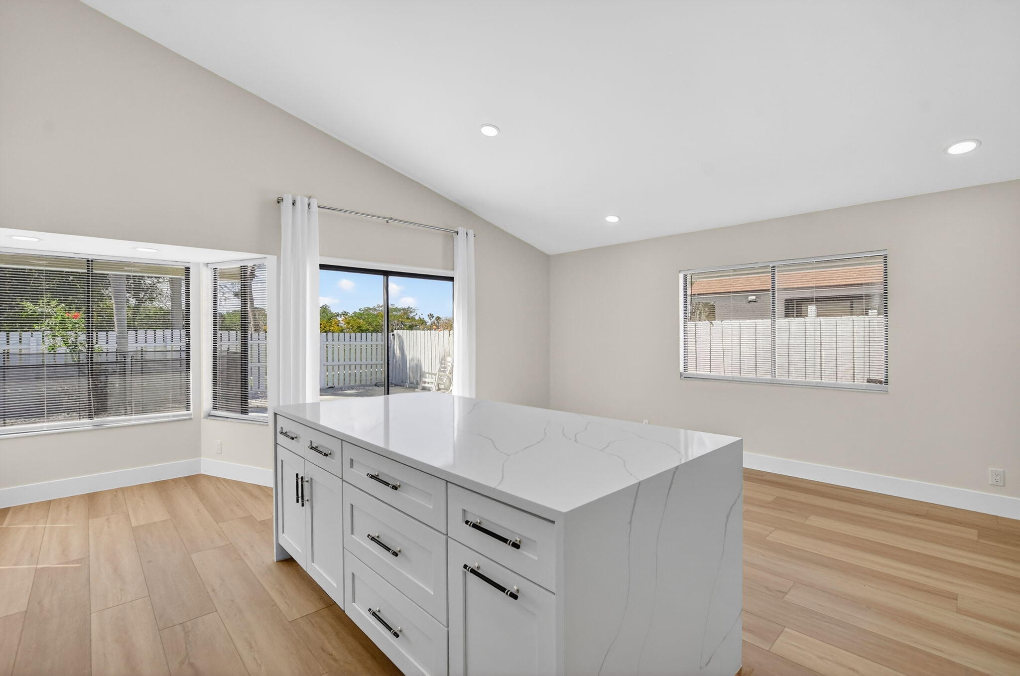 22732 Pickerel Circle Boca Raton, FL 33428 - Photo 19 of 38 a view of an empty room with wooden floor and a window