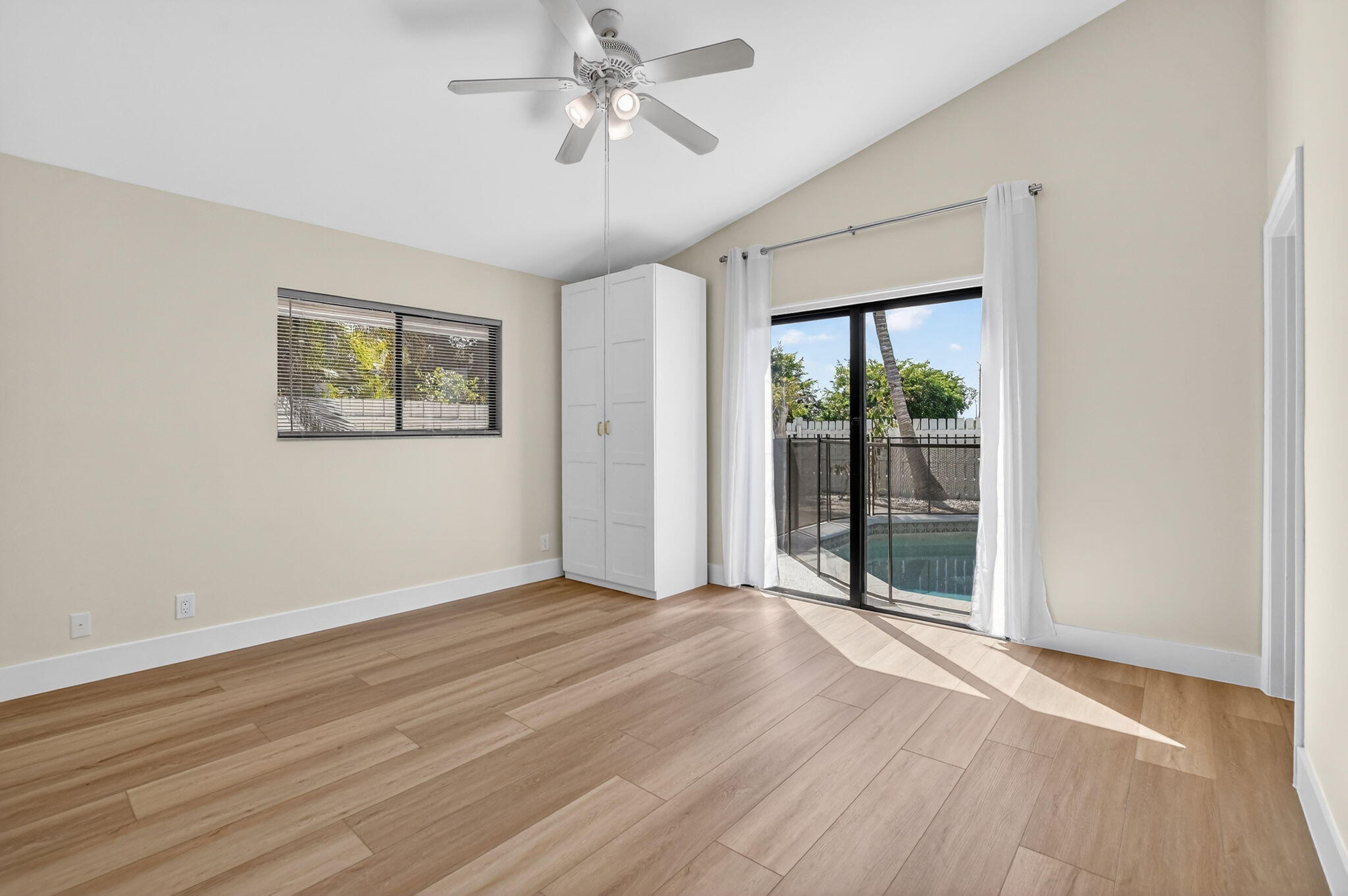 22732 Pickerel Circle Boca Raton, FL 33428 - Photo 20 of 38 a view of an empty room with a window and wooden floor
