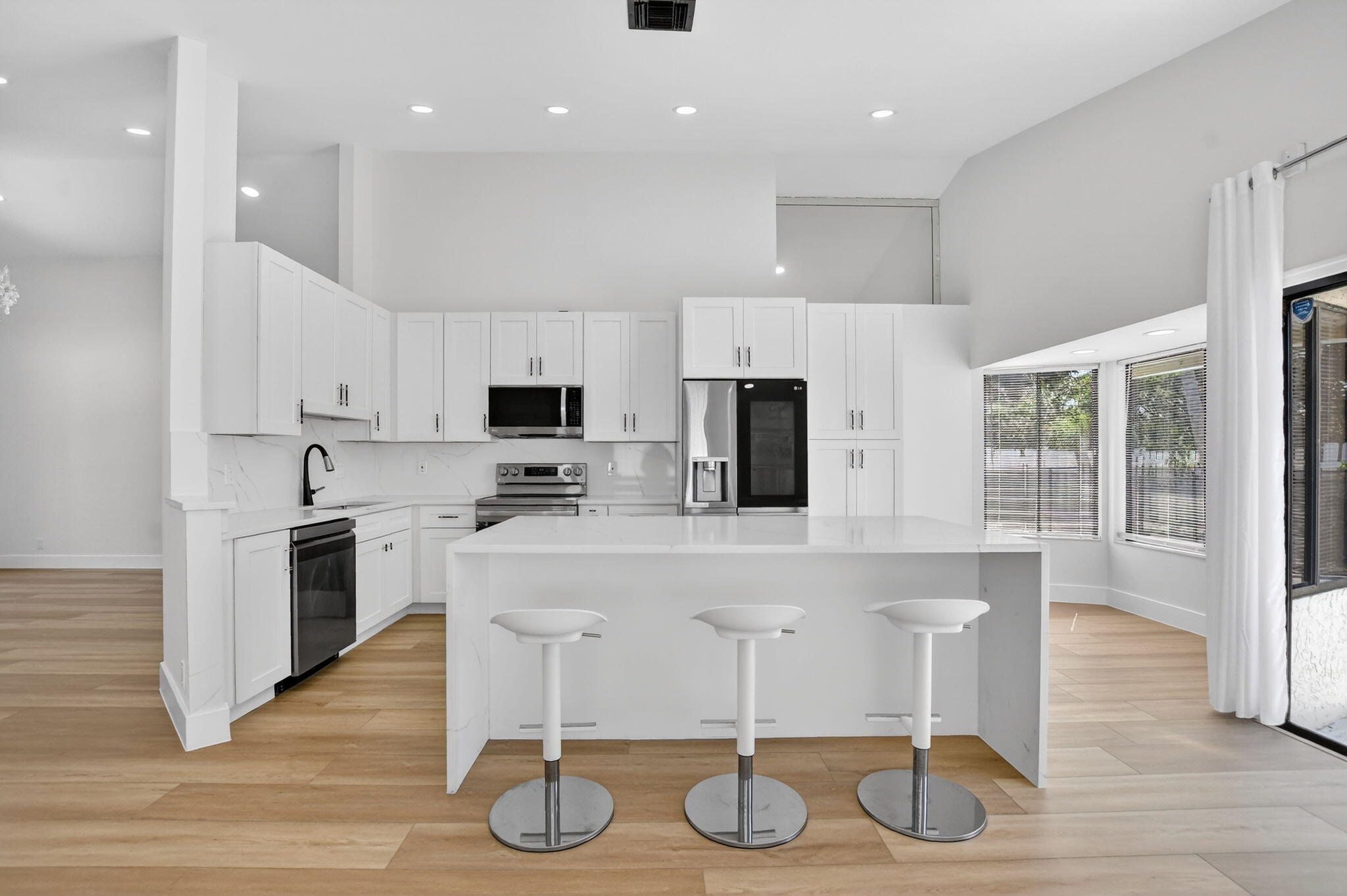 22732 Pickerel Circle Boca Raton, FL 33428 - Photo 2 of 38 a kitchen with stainless steel appliances kitchen island granite countertop a stove a sink and a refrigerator